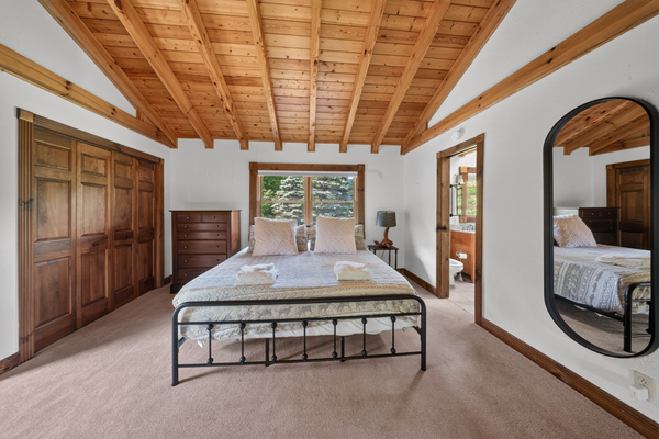 Loft bedroom with king size memory foam bed and entrance to the primary bath. 