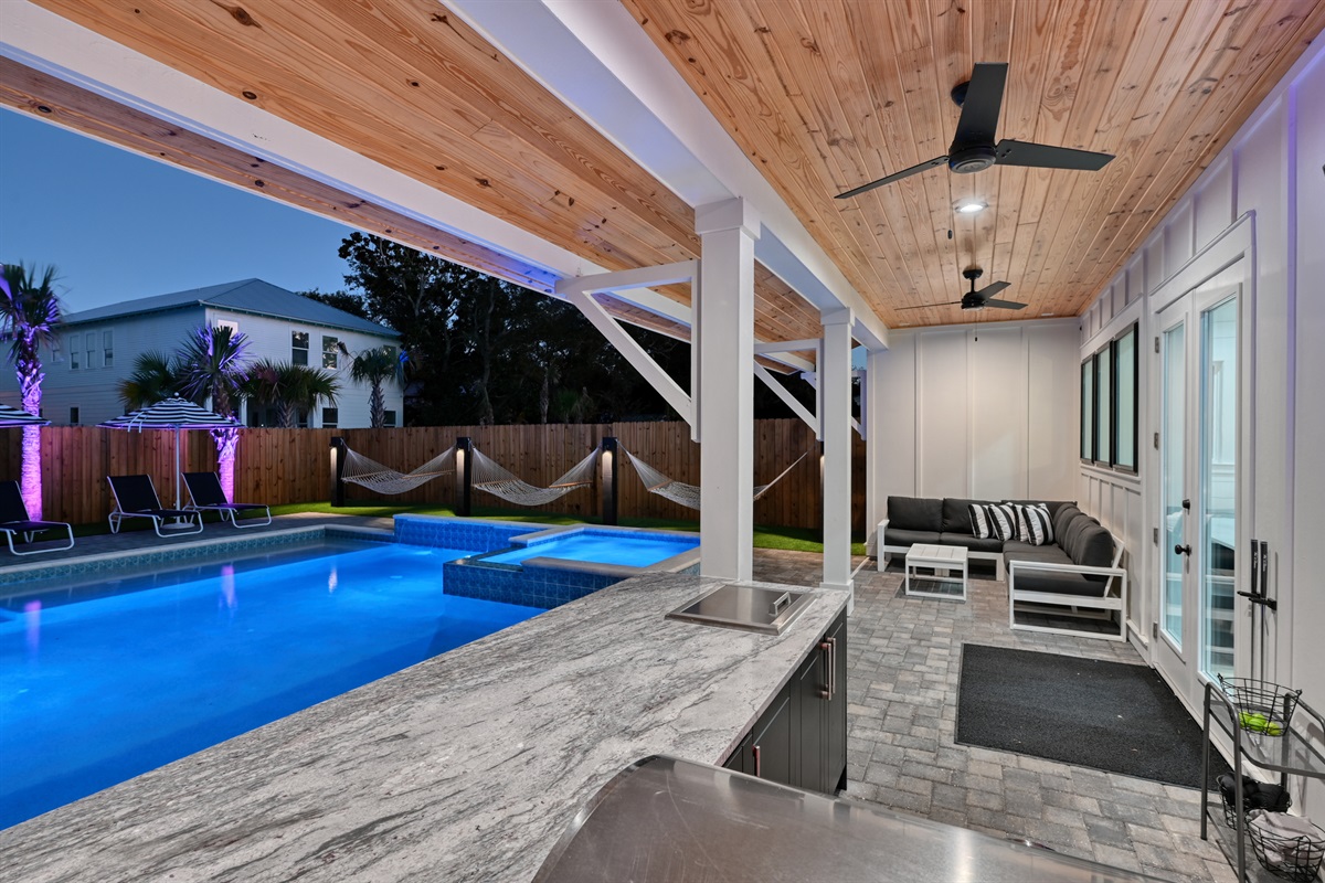 Extended covered patio with large L Shaped lounge and Summer Kitchen with grill, 50" Smart TV
