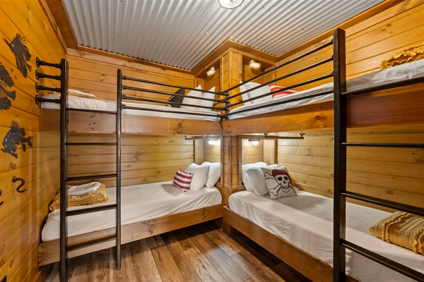 Pirate-Themed Double Bunk Room with Wheelchair-Friendly Lower Beds, Grab Bars for Support, and USB Charging Ports.
