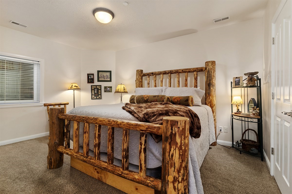 Rustic charm meets comfort in this cozy guest bedroom with a king bed and a double bed trundle.