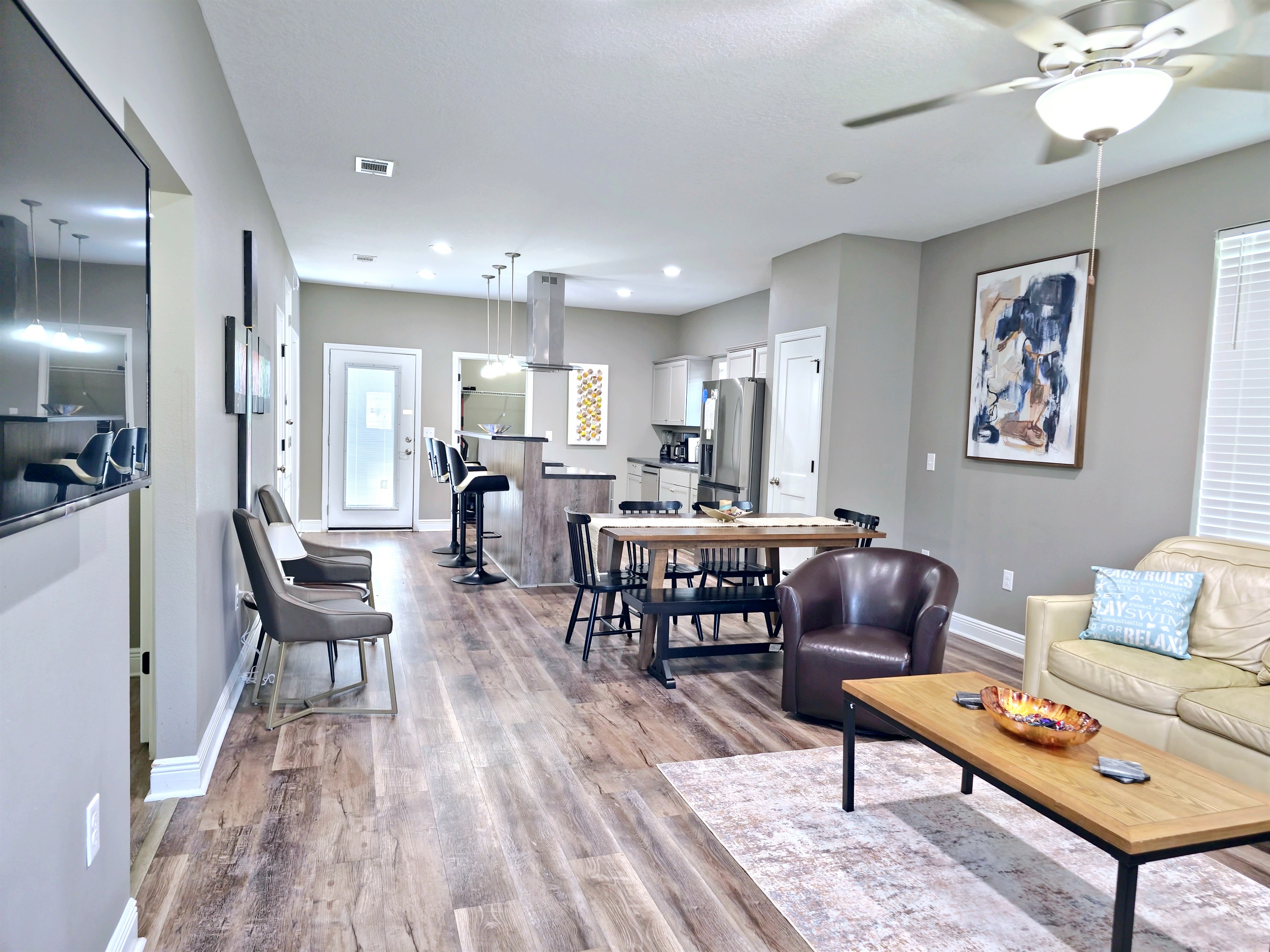 Large wall mounted smart TV in the Livingroom and LVP flooring