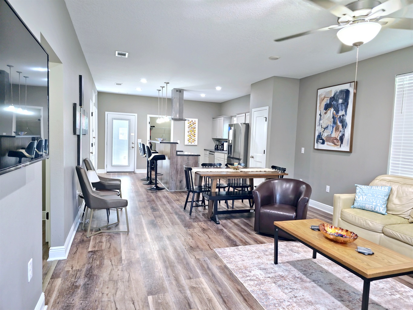 Large wall mounted smart TV in the Livingroom and LVP flooring