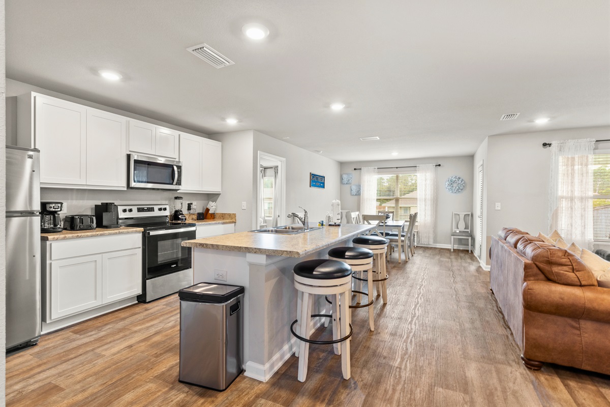 Fully stocked modern kitchen with stainless steel appliances, perfect for preparing seaside feasts.