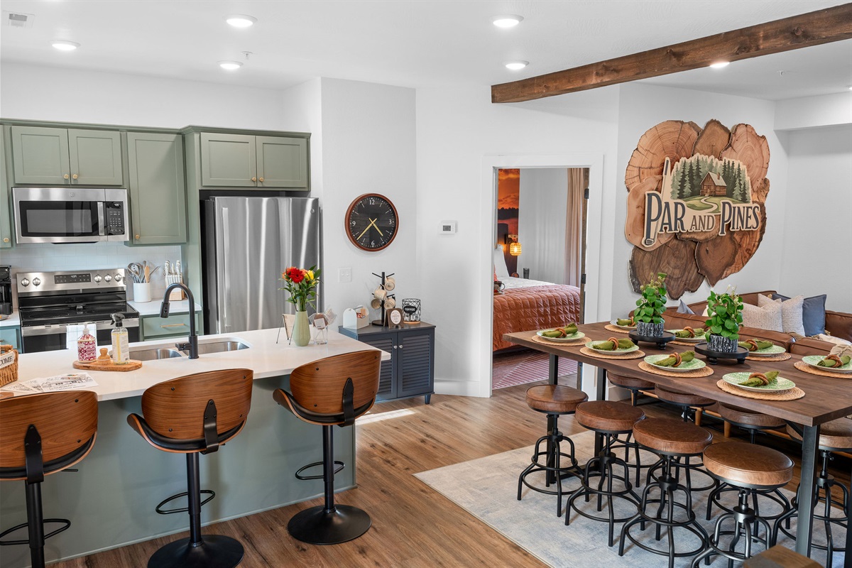 A fully-stocked kitchen and dining area for preparing meals together, enjoying time and laughing while eating cooked meals or takeout pizza from the general store.