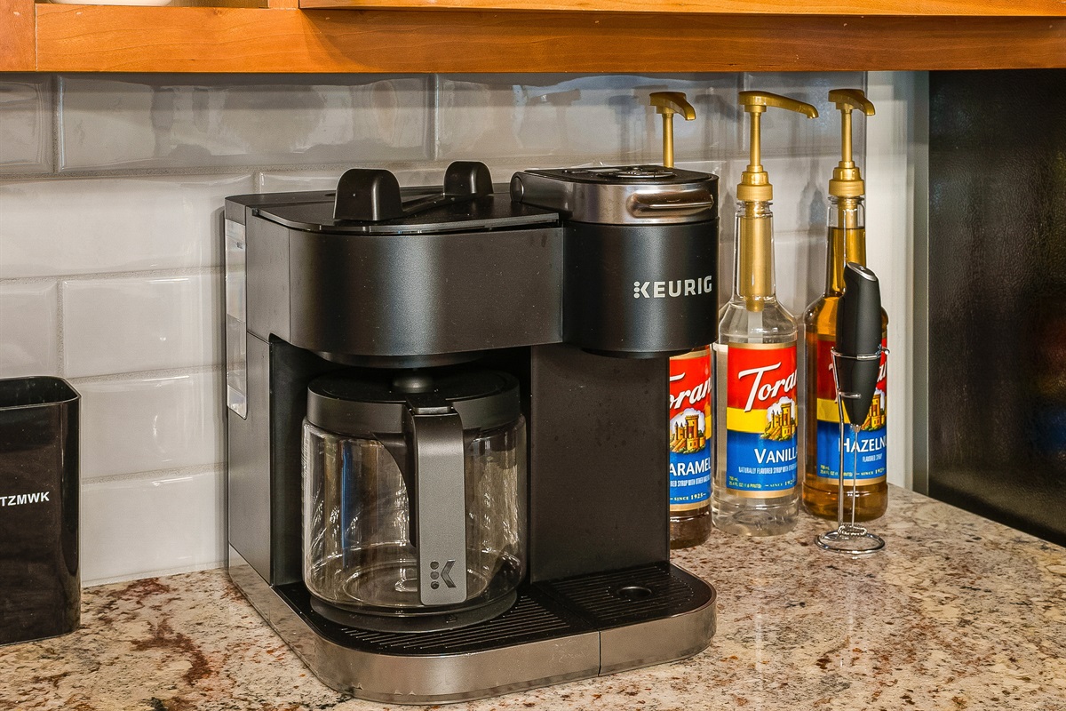 Keurig, drip carafe, tea, coffee, and sugar all lined up — the coffee station is stocked and ready before you even unpack.