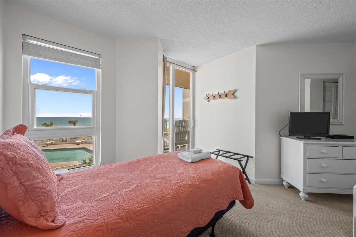 A relaxing bedroom with natural light and a peaceful coastal vibe