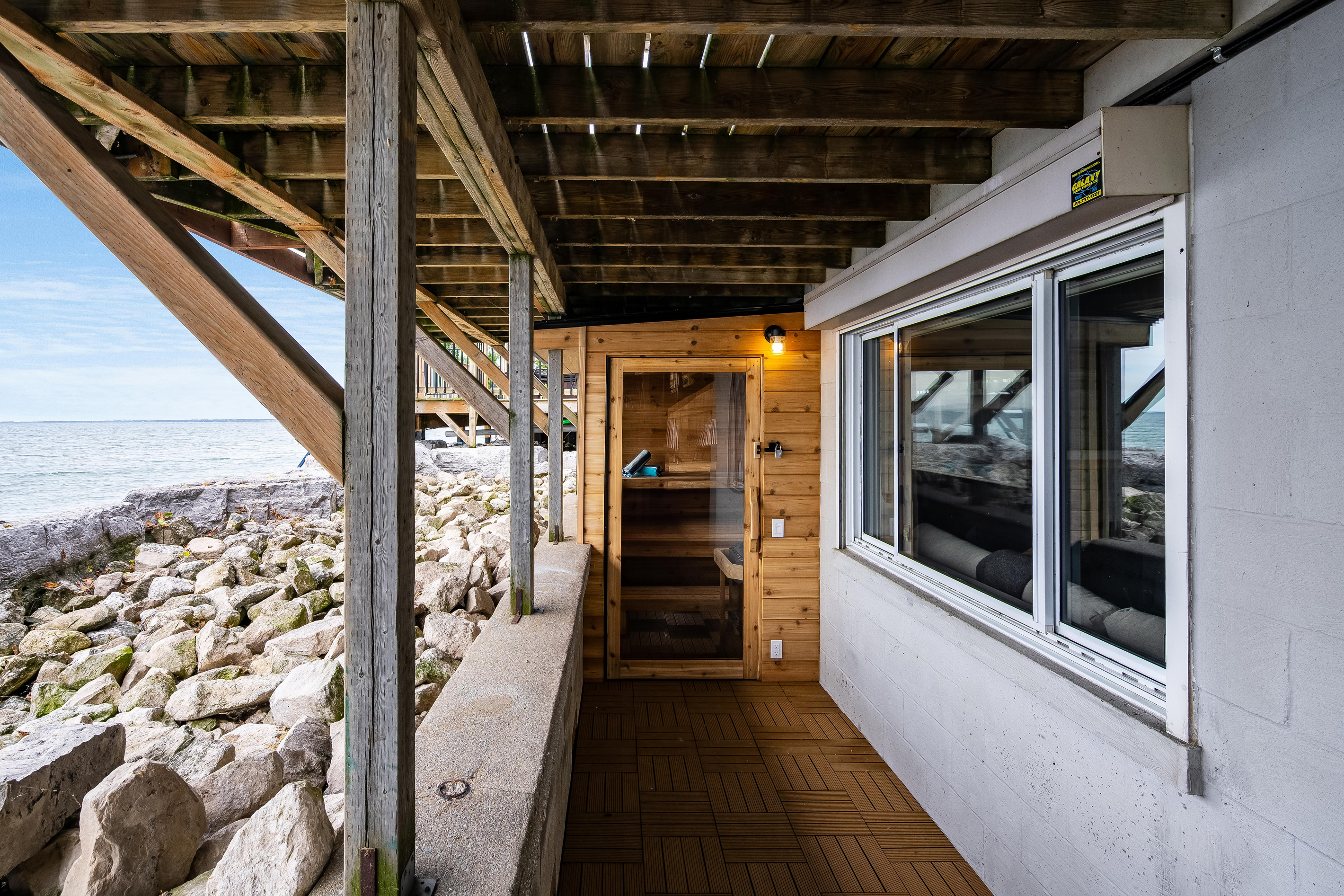 Private sauna entrance tucked beneath the waterfront deck.