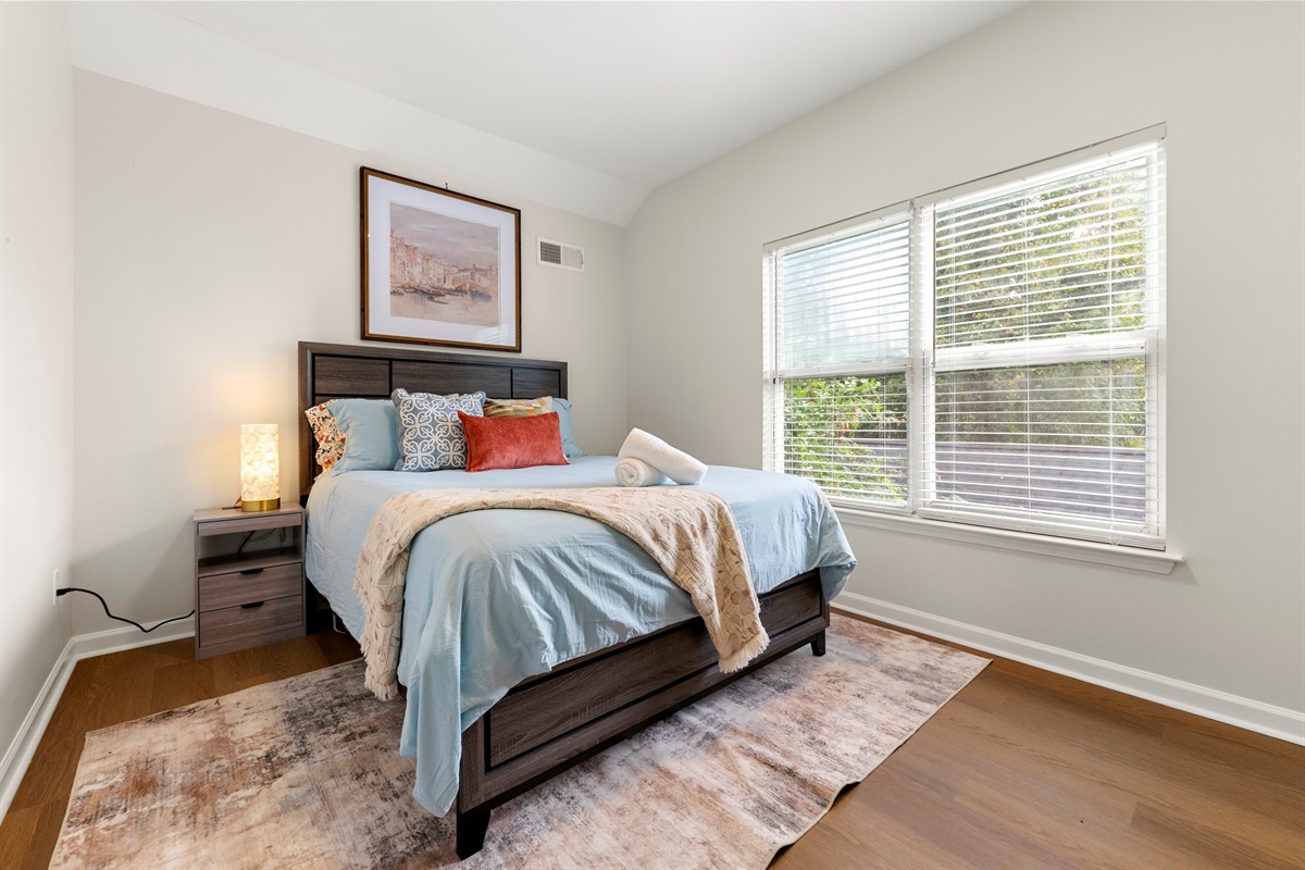 Sunlit room with cozy bedding and a peaceful ambiance.