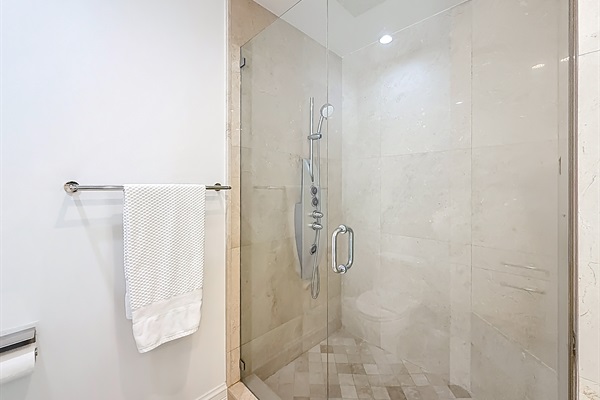 Large marble shower with body jets. 