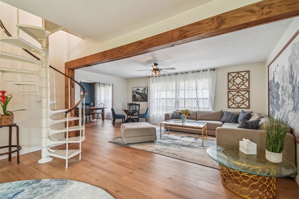 The living room includes a spiral stairway up to the kids' loft.