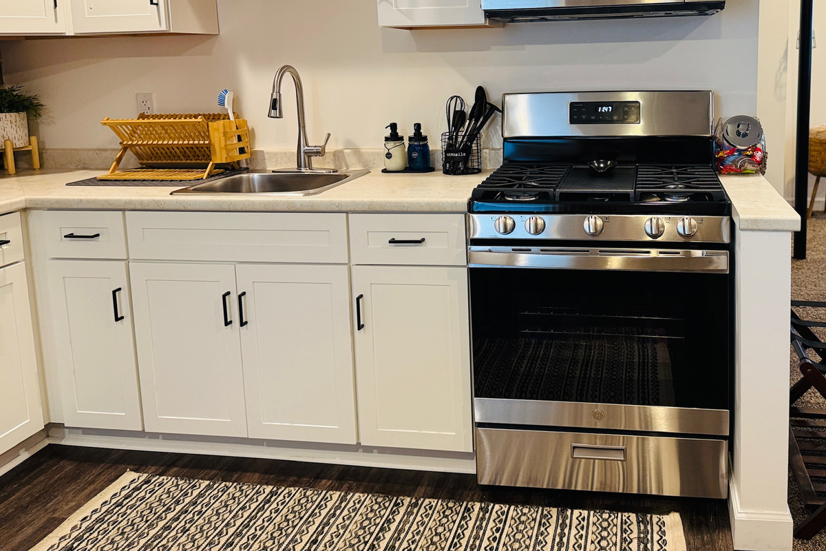 Kitchen includes a gas range, sink, and generous food-preparation space.