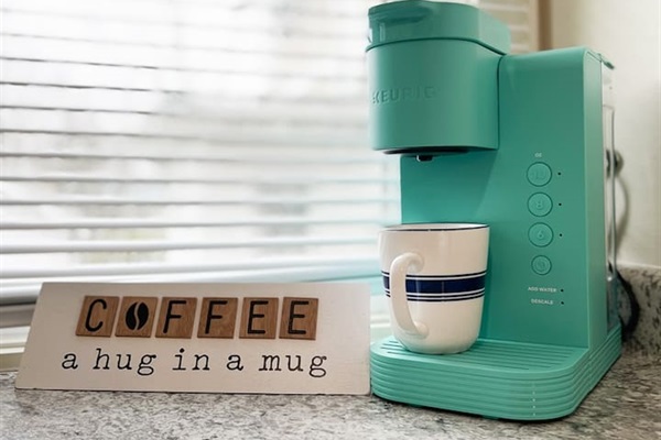 Full kitchen featuring a sleek coffee maker, perfect for coffee lovers, with a motivational touch to inspire the love of coffee. A cozy, functional space designed for brewing your favorite cup and adding warmth to your kitchen experience