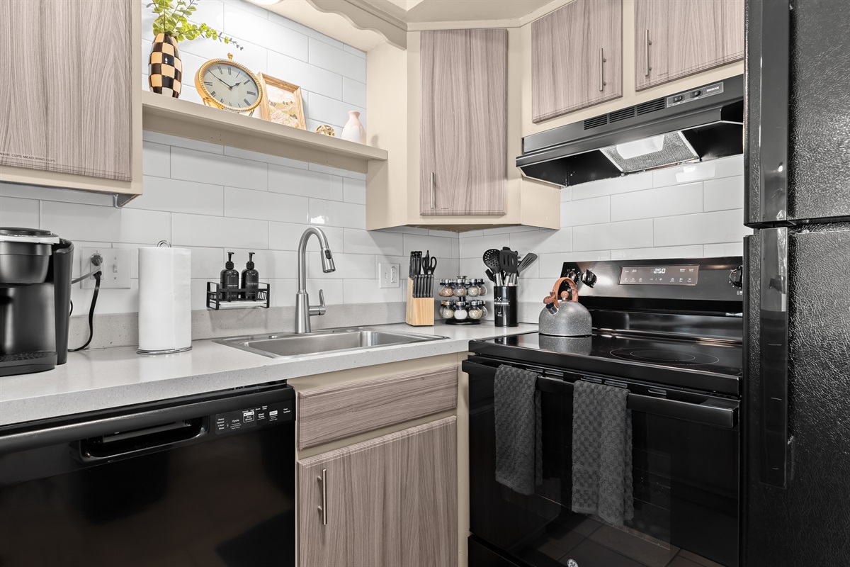 Fully stocked kitchen with quality appliances and ample prep space.