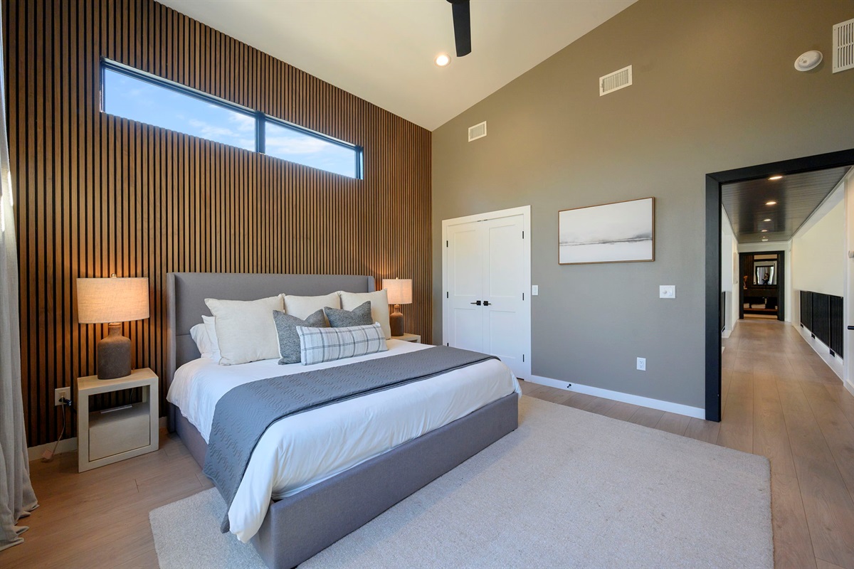 King Suite 2 - Large and spacious suite with teak wood paneling, designer finishes, smart TV, premium king mattress, and luxury bedding. Includes stunning views of the hardwood forest. 