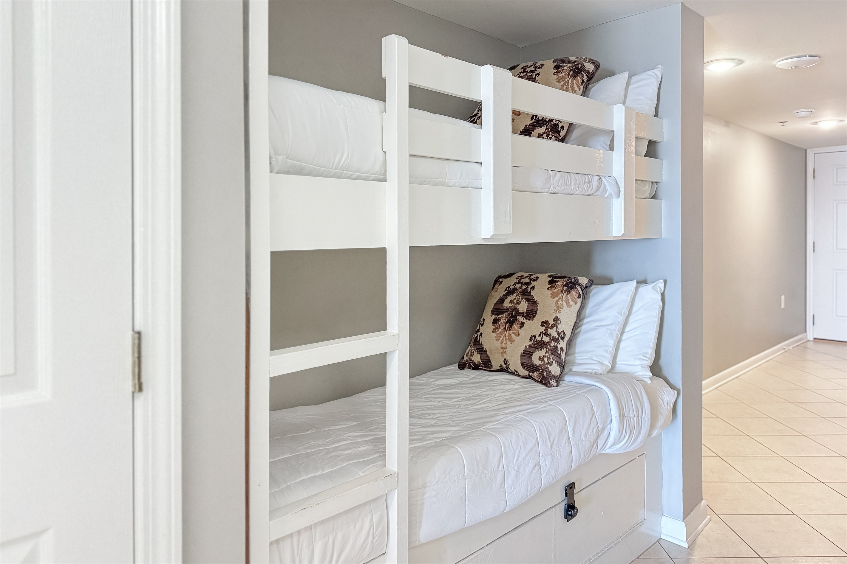 Maximize your space with these cozy built-in bunk beds, providing extra sleeping arrangements for your guests.