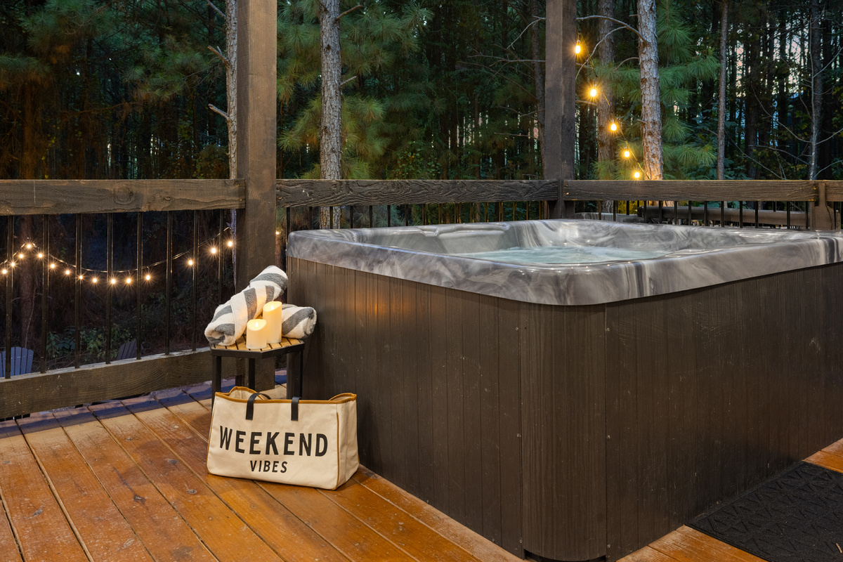 Weekend vibes, literally. Hot tub, glowing string lights, towering pines, and the kind of peaceful evening you wish could last a little longer.