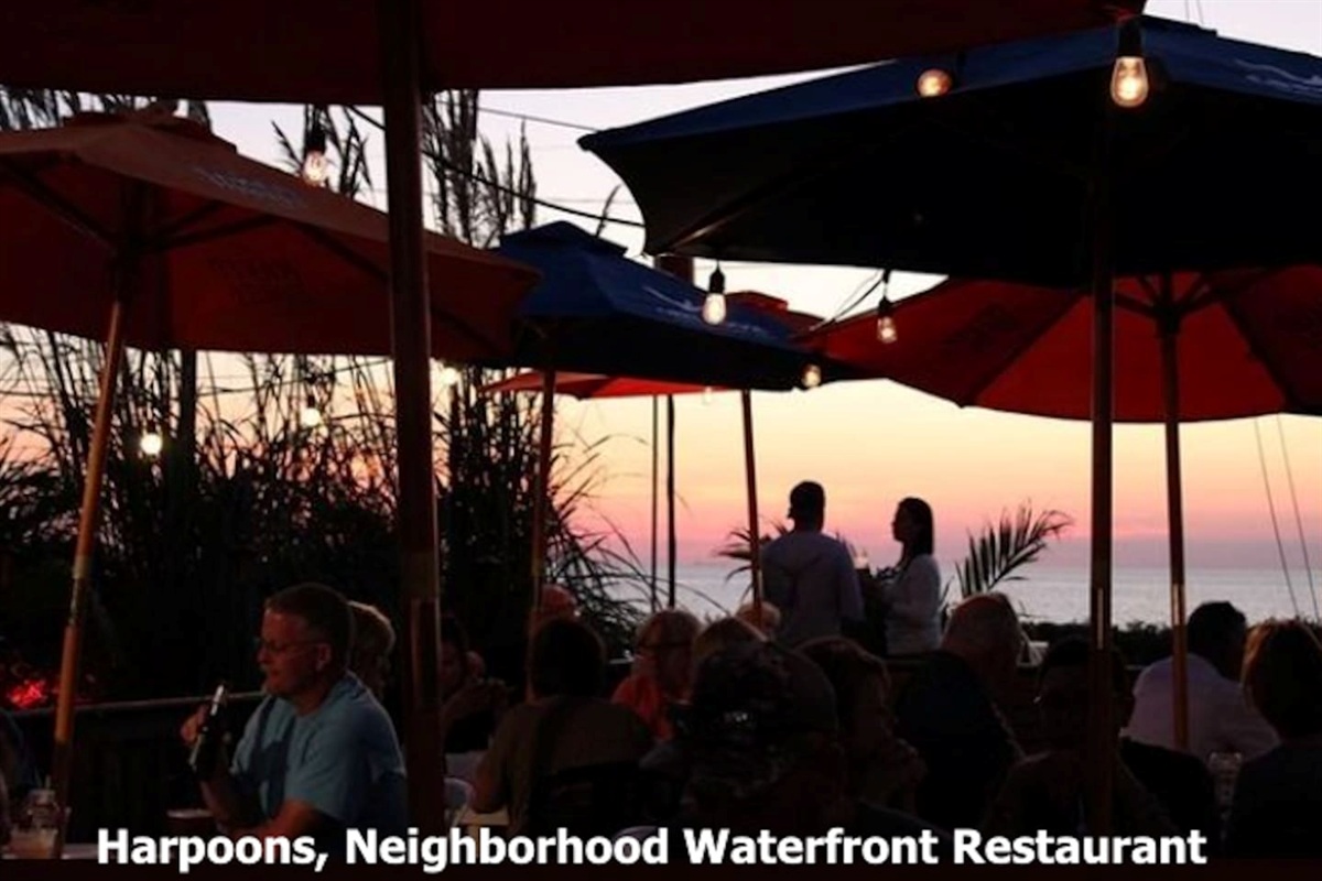 Enjoy a vibrant evening at Harpoons, a popular local waterfront restaurant. Dine al fresco under colorful umbrellas and string lights, taking in the beautiful sunset views over the water with friends and family.