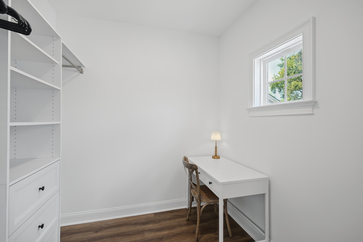 Large walk-in closet with a quiet desk nook, ideal for remote work