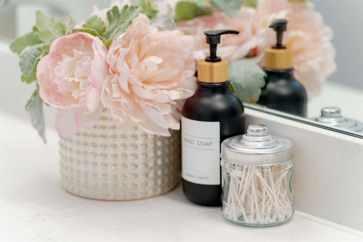 Elegant bathroom counter with floral accents and luxury touches.