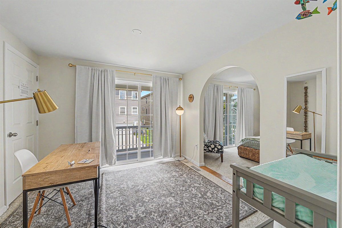 5th bedroom has a changing table, pack n play and closet with high chair, bed guard rail