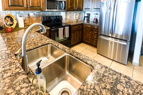 Well-equipped kitchen with major appliances and breakfast bar for two.