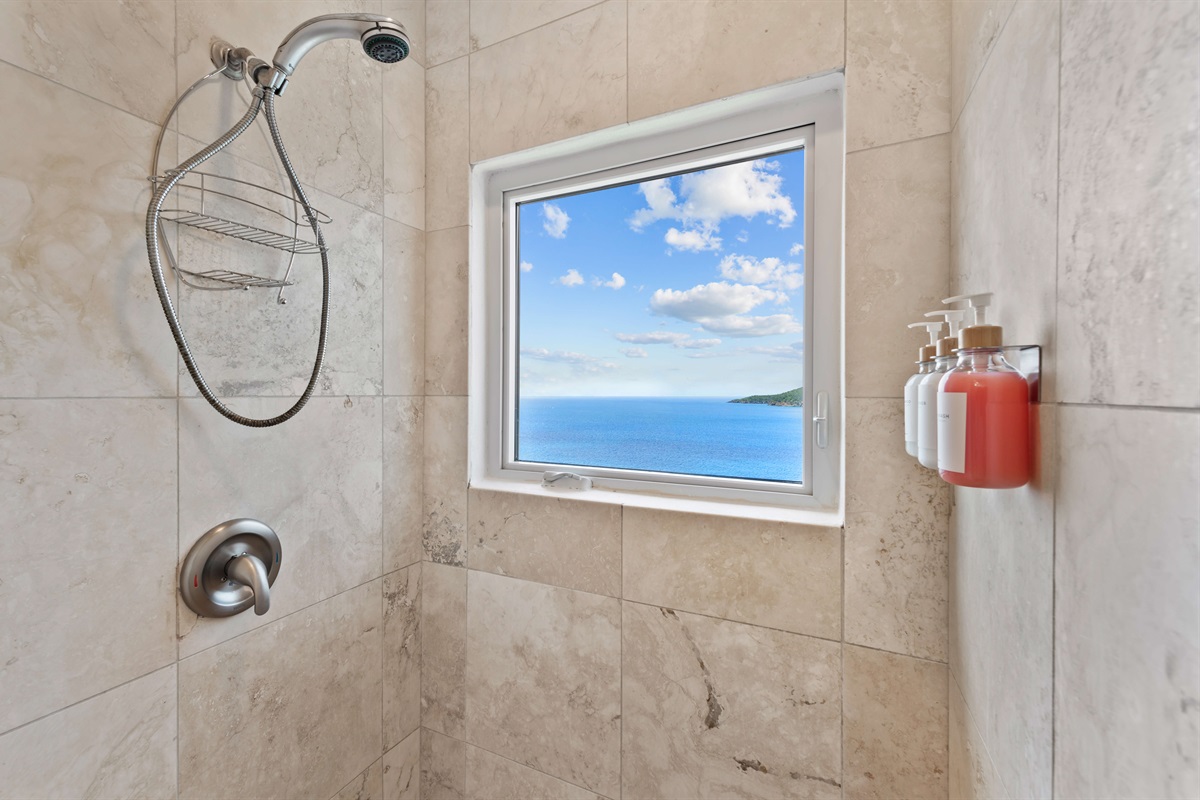 Sleek en-suite with double vanity, hair dryer, walk-in shower  and soft lighting. Functional and elegant.