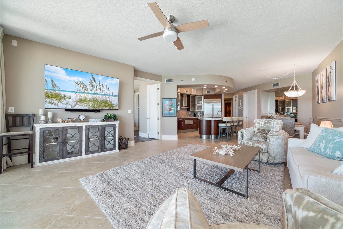 Experience the epitome of coastal living in this beautifully designed living room. Featuring plush furnishings, a serene color palette, and expansive views, this space offers a tranquil retreat for residents and guests alike.