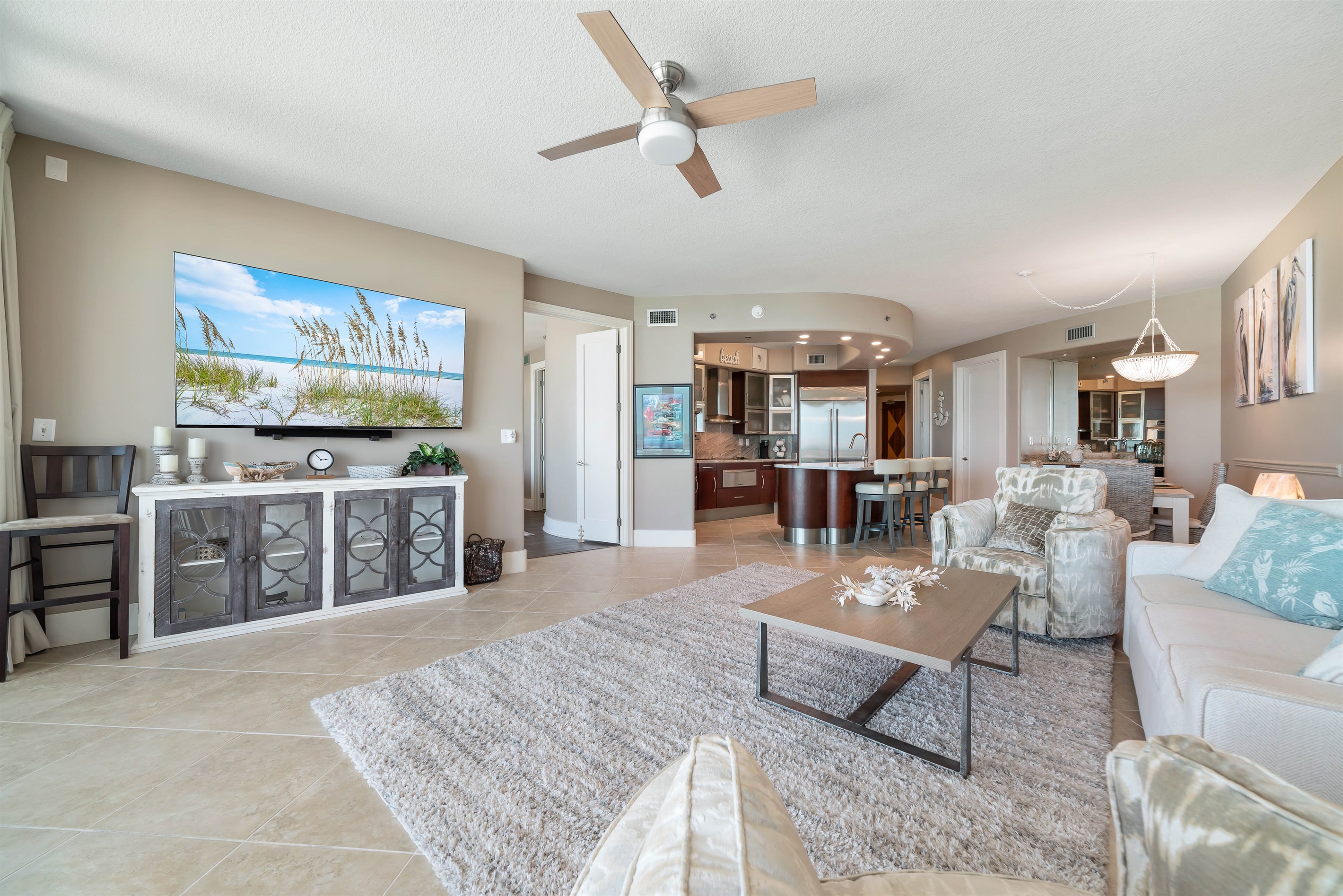 Experience the epitome of coastal living in this beautifully designed living room. Featuring plush furnishings, a serene color palette, and expansive views, this space offers a tranquil retreat for residents and guests alike.