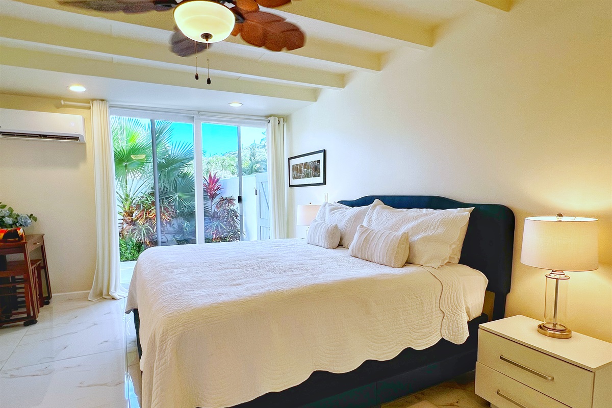 Unwind in a bedroom that feels open and serene, offering direct access to fresh air and island breezes.