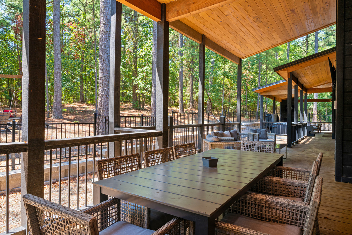 Gather around the outdoor dining table for a meal in the fresh air, with plenty of seating and peaceful wooded views all around.