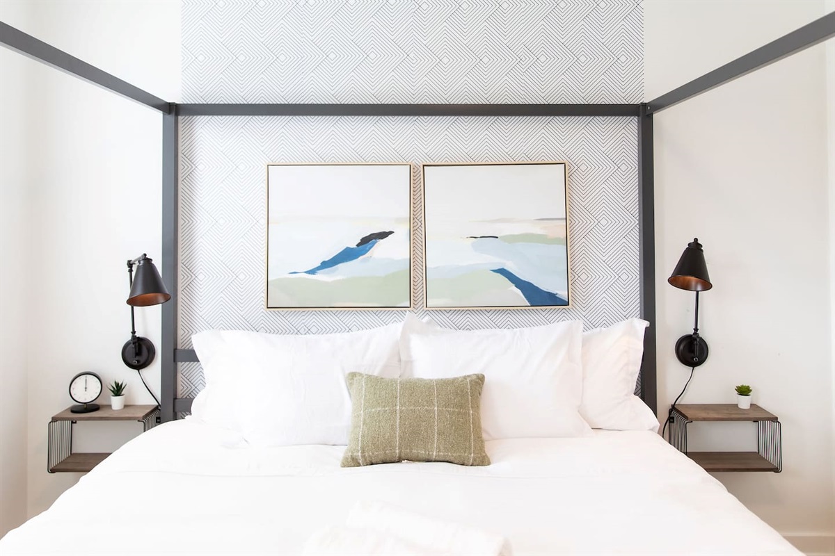 Serene bedroom with a calming white interior, featuring simple yet elegant décor that creates a peaceful and restful retreat.