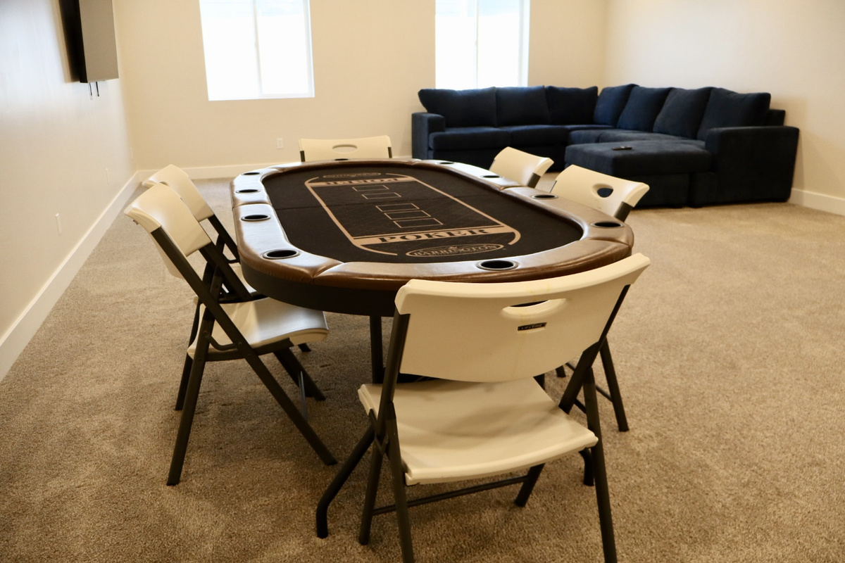 This spacious rec room features recessed lighting and two bright windows, creating the perfect setting for fun and relaxation—furnishings and games coming soon!