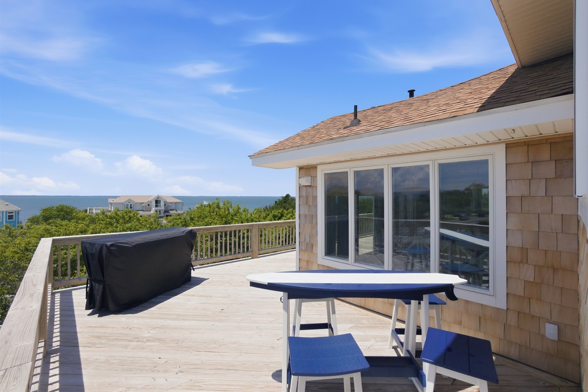 Expansive upper deck with outdoor dining area and beautiful water views