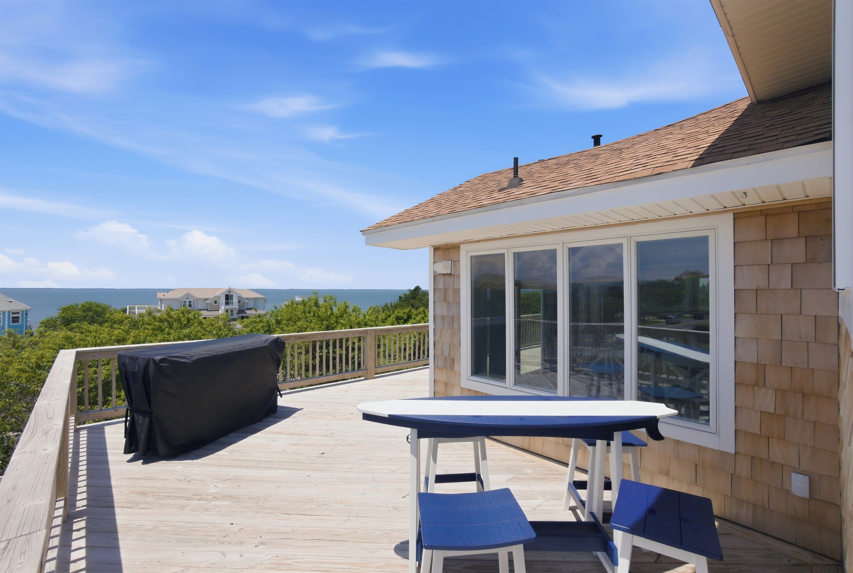 Expansive upper deck with outdoor dining area and beautiful water views