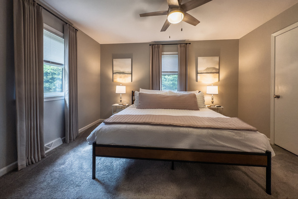 King bed, 55" Smart TV, ceiling fan, two led light nightstands with multiple charging ports, two multi light function lamps, blackout curtains, dual closets.