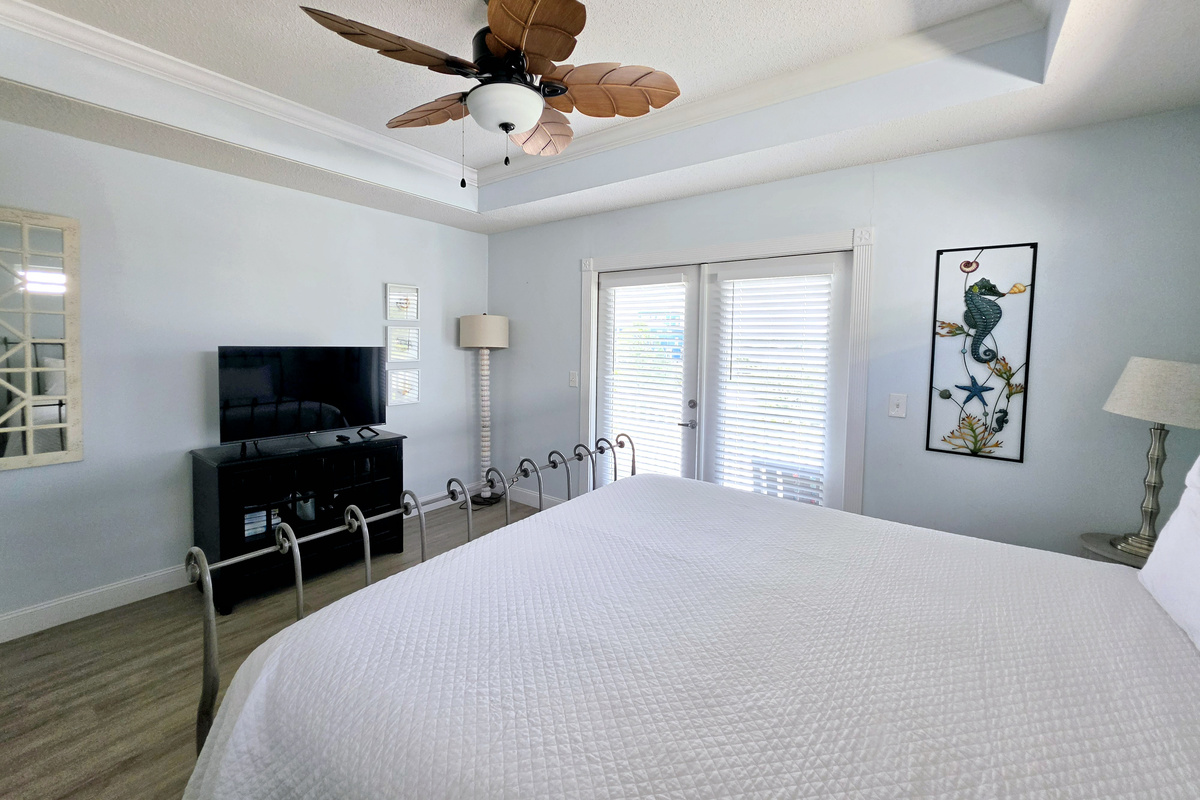 Primary bedroom with king bed and TV