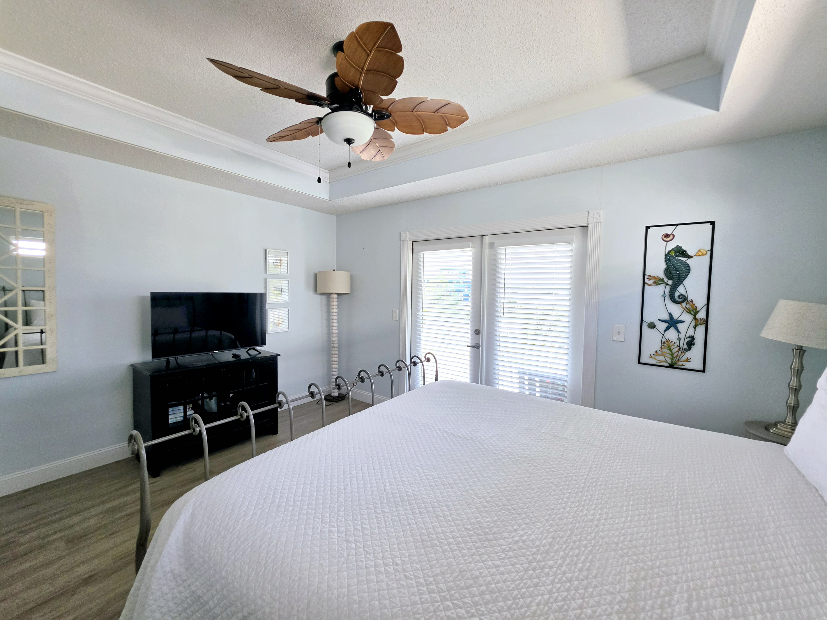 Primary bedroom with king bed and TV