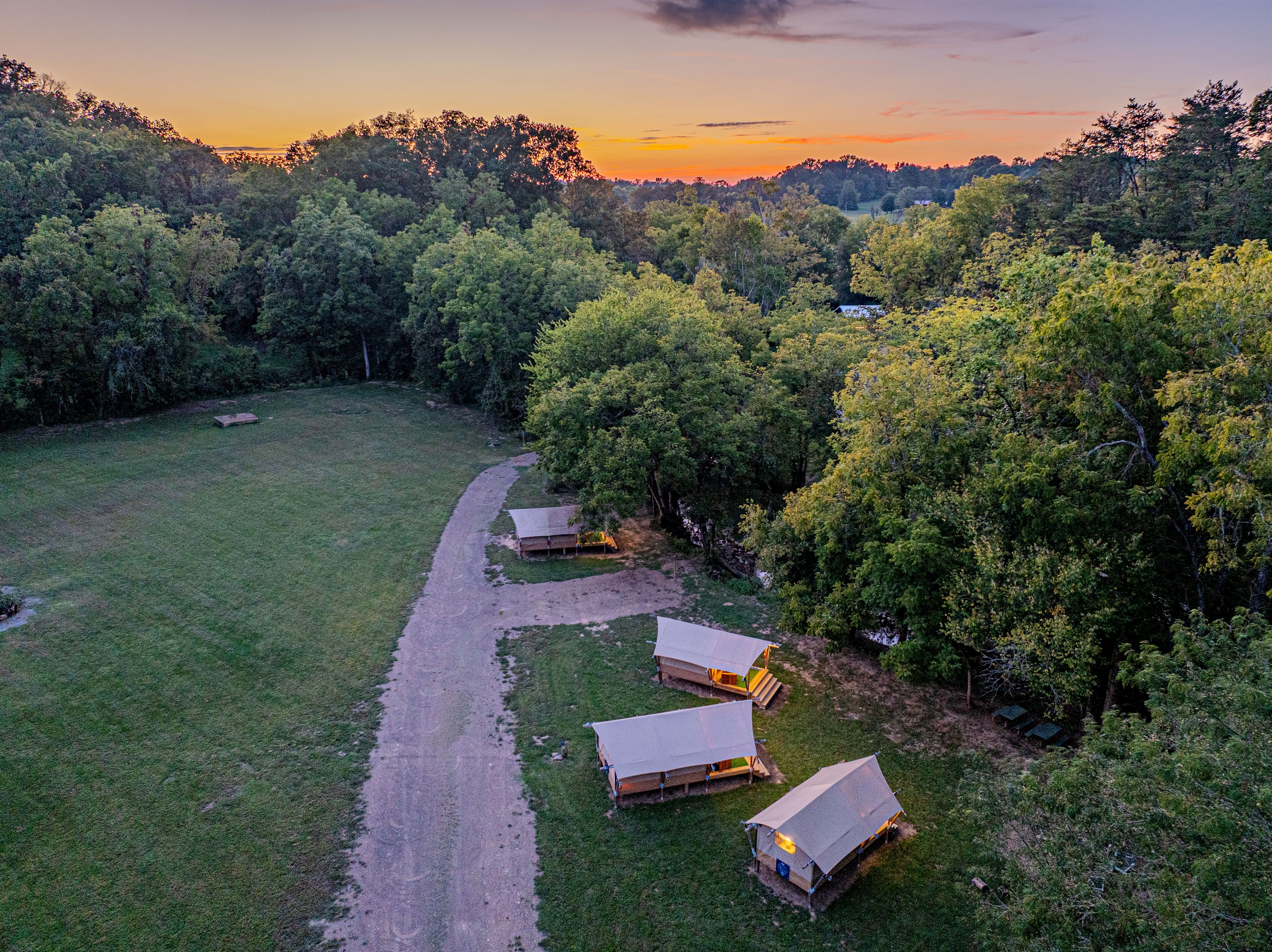 Golden hour at your Smoky Mountain escape. As the sun sets over the trees, the site comes alive. Settle into your cozy tent for a peaceful night under the wide-open sky.