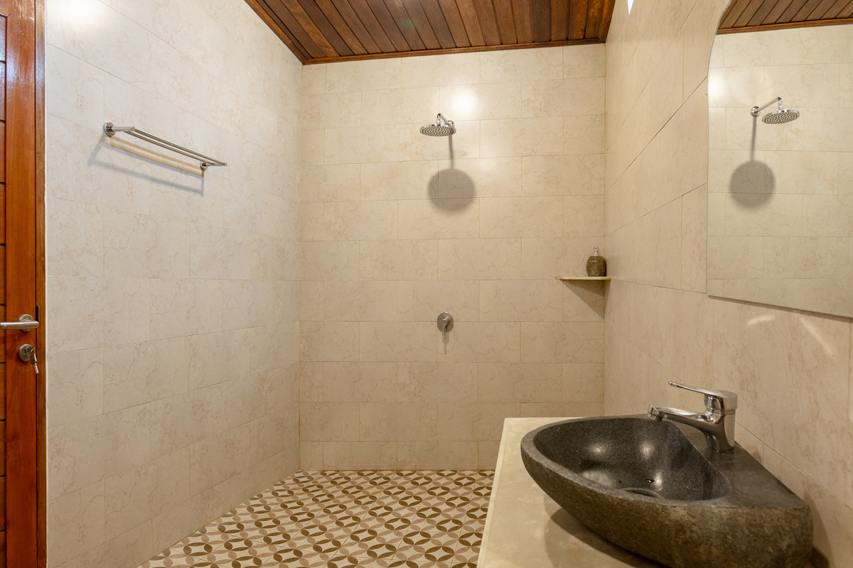 Your spacious private bathroom, featuring a large, comfortable walk-in shower.