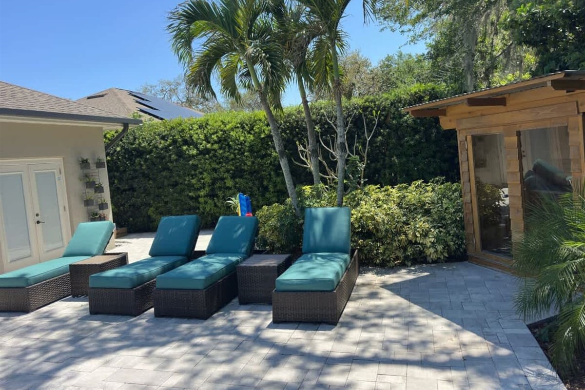 Kick back on poolside loungers under the shady pergola.