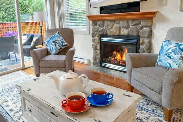 Enjoy coffee or tea by the fireplace in spacious livingroom. Sliding glass doors to oversized patio.
