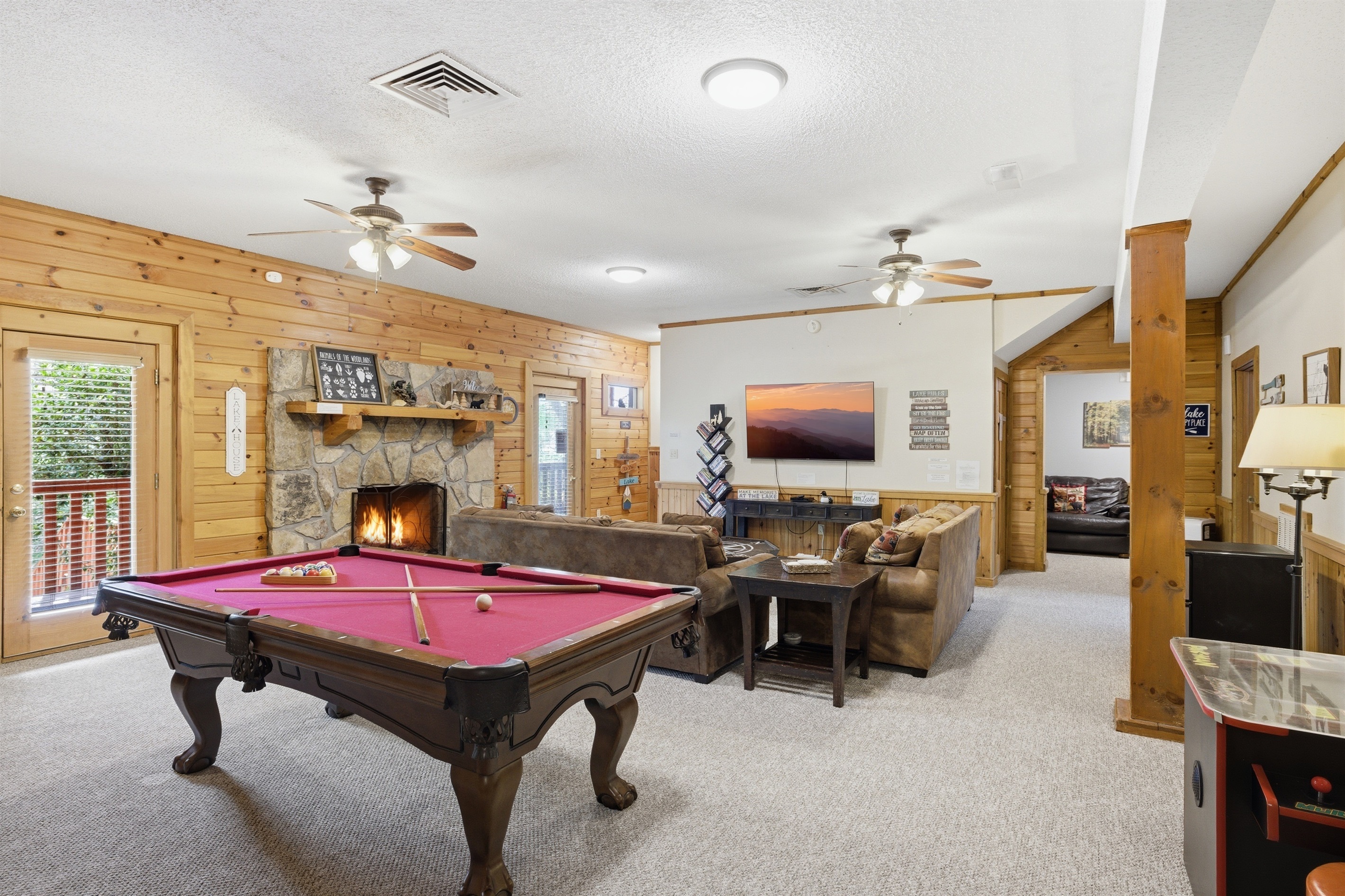Lower-Level Living Room with Pool table, Game Table and Gas Fireplace.