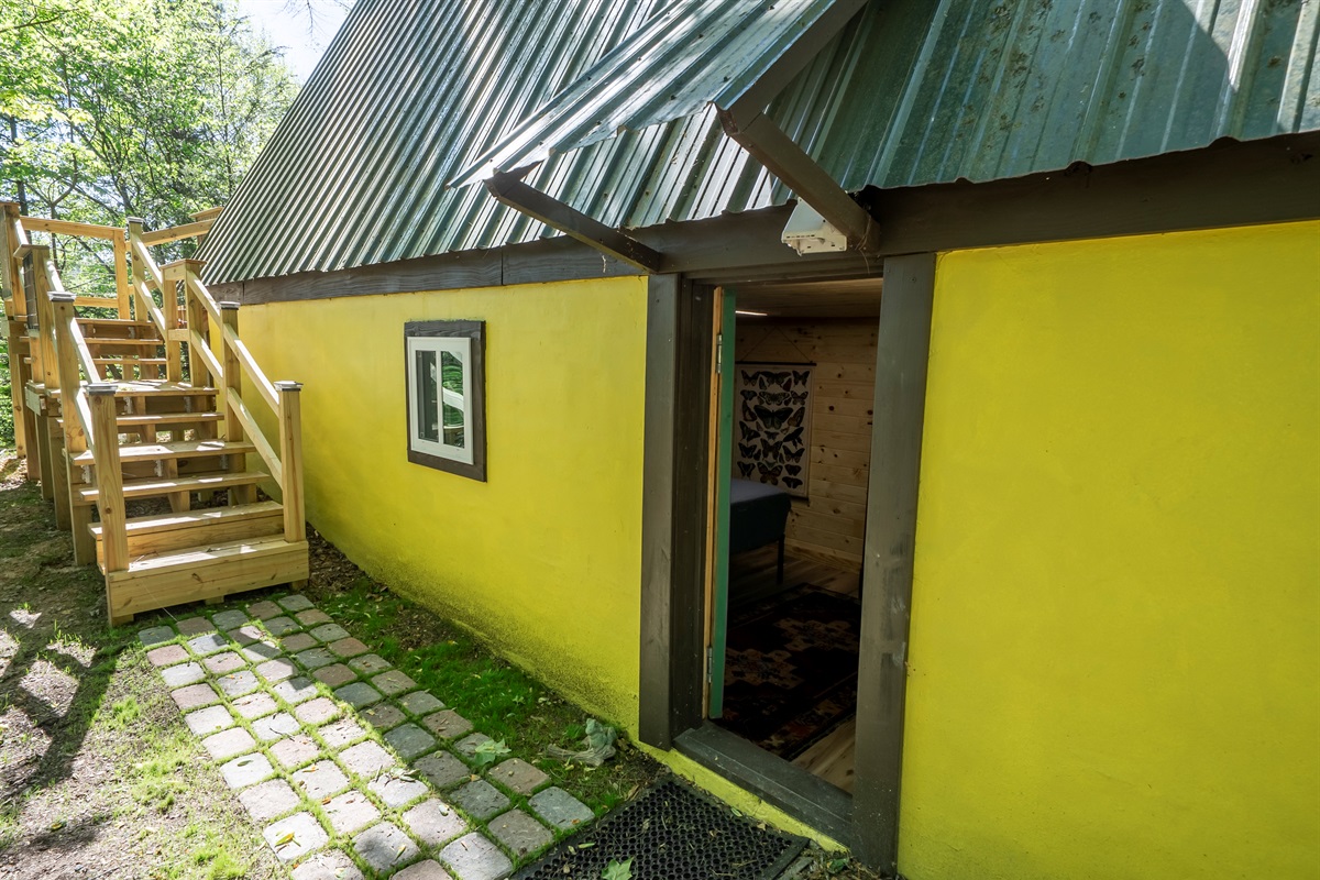 Private exterior entrance leads directly to the lower-level bedroom