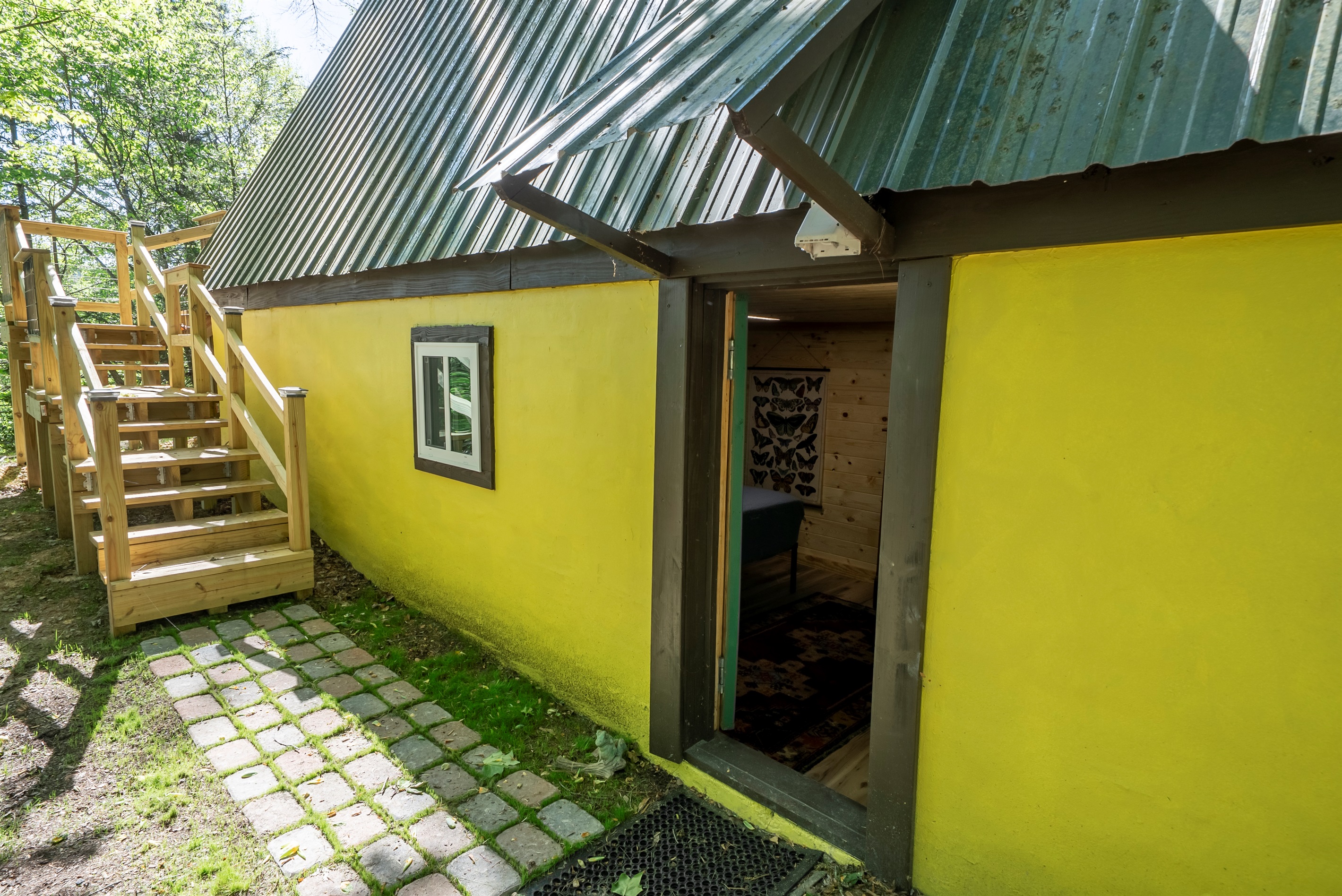 Private exterior entrance leads directly to the lower-level bedroom