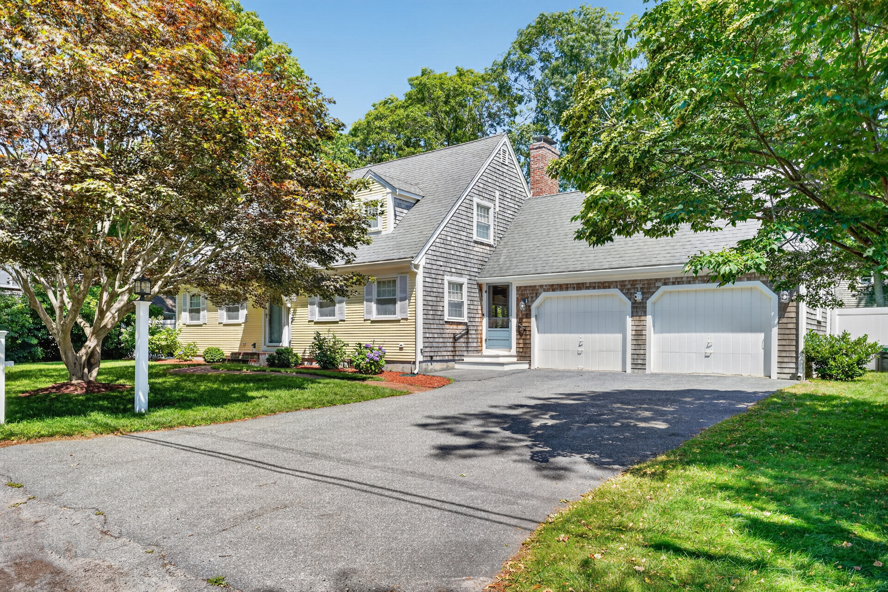 Welcoming front entrance with ample driveway parking and charming curb appeal.