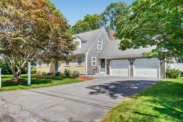 Welcoming front entrance with ample driveway parking and charming curb appeal.