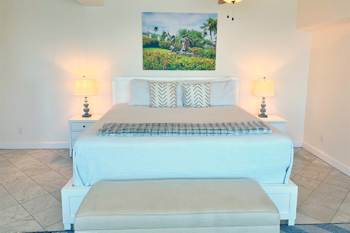 Bedroom's soft tones and luxury linens invite restful nights.