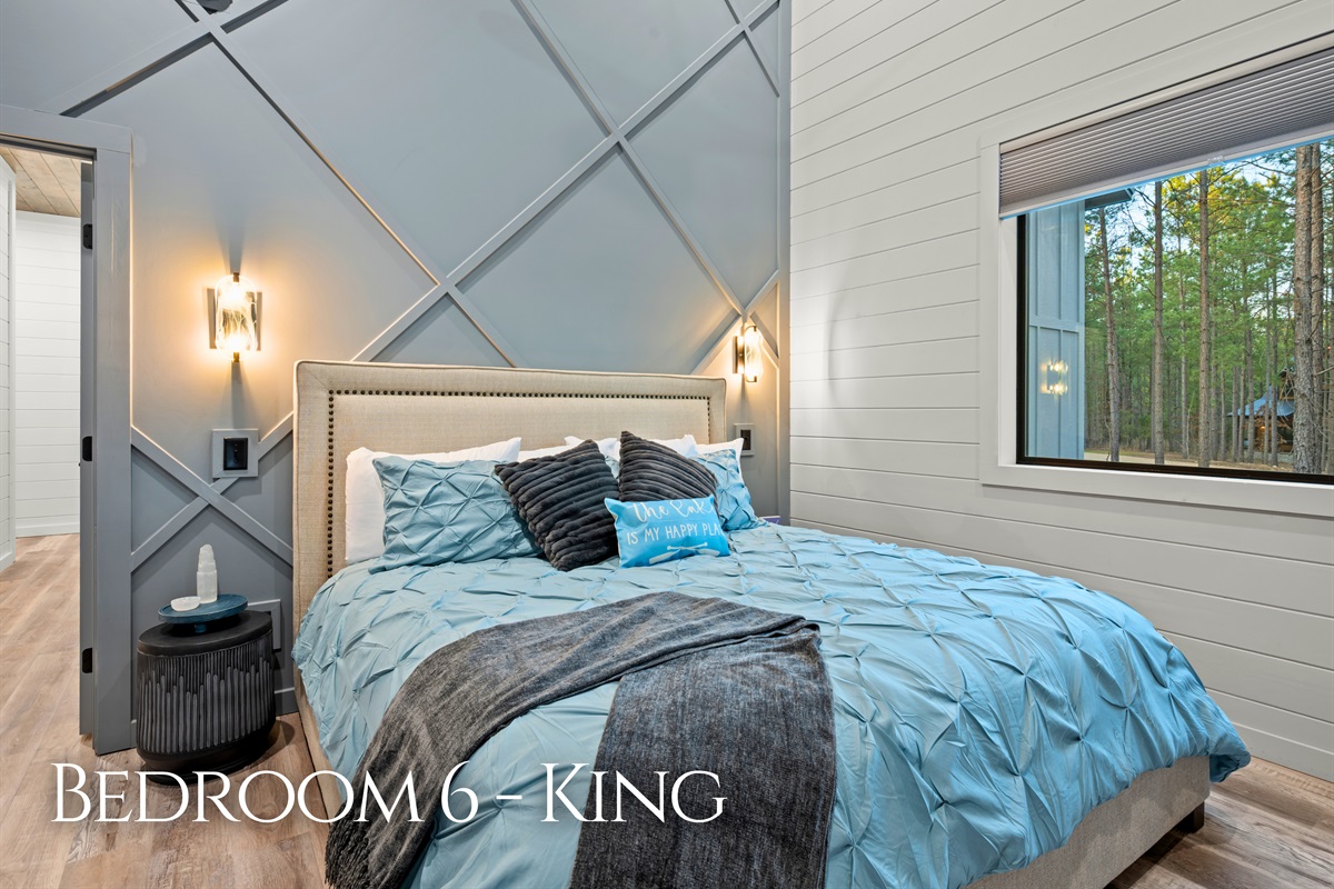 Soft bedding and peaceful décor give this king bedroom a calm and comfortable atmosphere for restful nights.