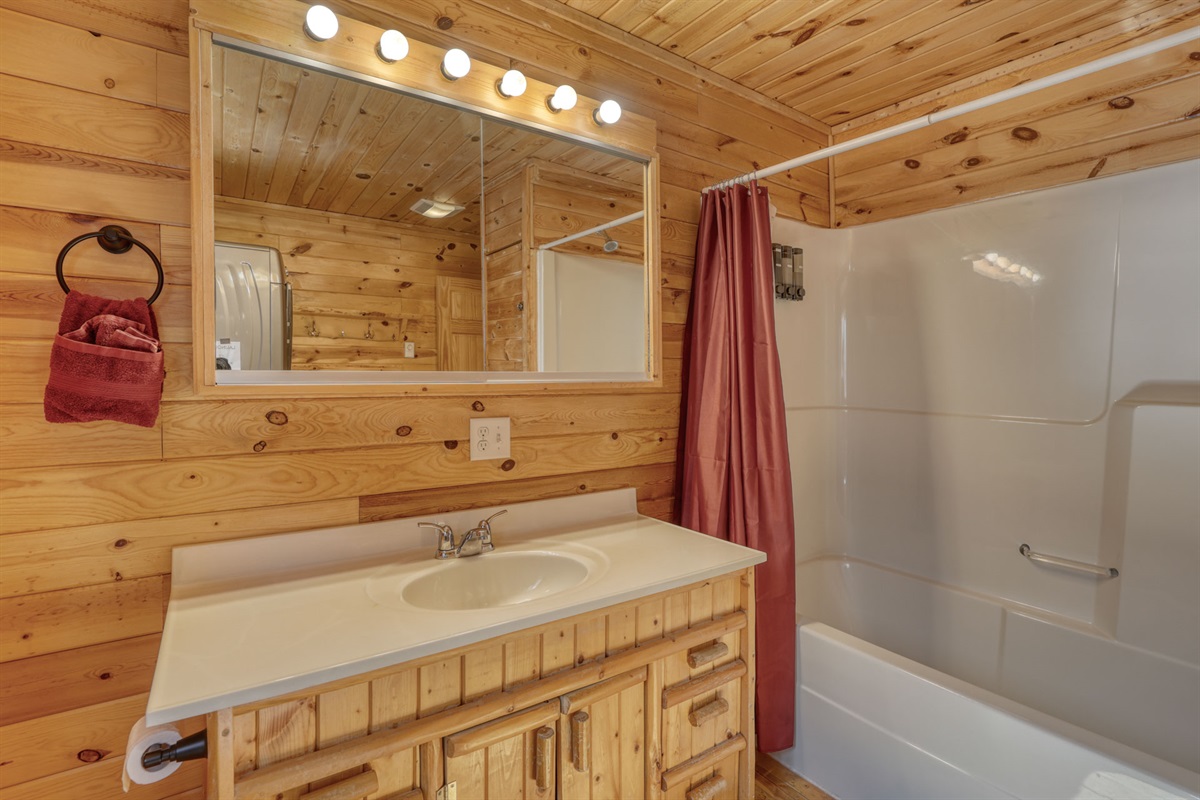 Bathroom with bath and washer and drier