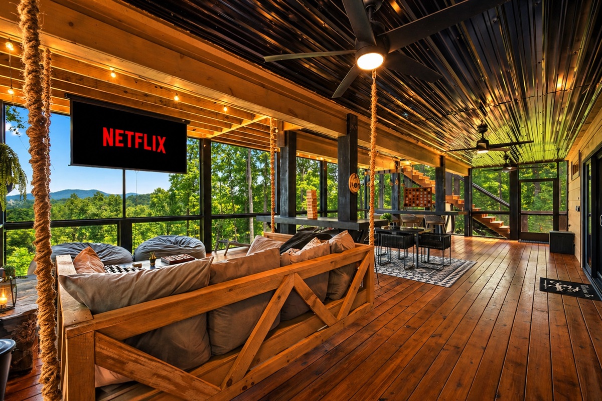 Spend the day on the screened-in porch with queen-size swing bed, movie projector, games, hot tub, fireplace and spectacular views. 